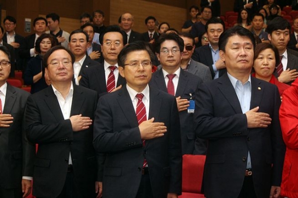 지난달 24일 국회의원회관 대회의실에서 진행된 ‘북한 인권’ 영화 <퍼스트 스텝> 상영회에 앞서 국기에 대한 경례를 하고 있는 황교안 대표(가운데). 
